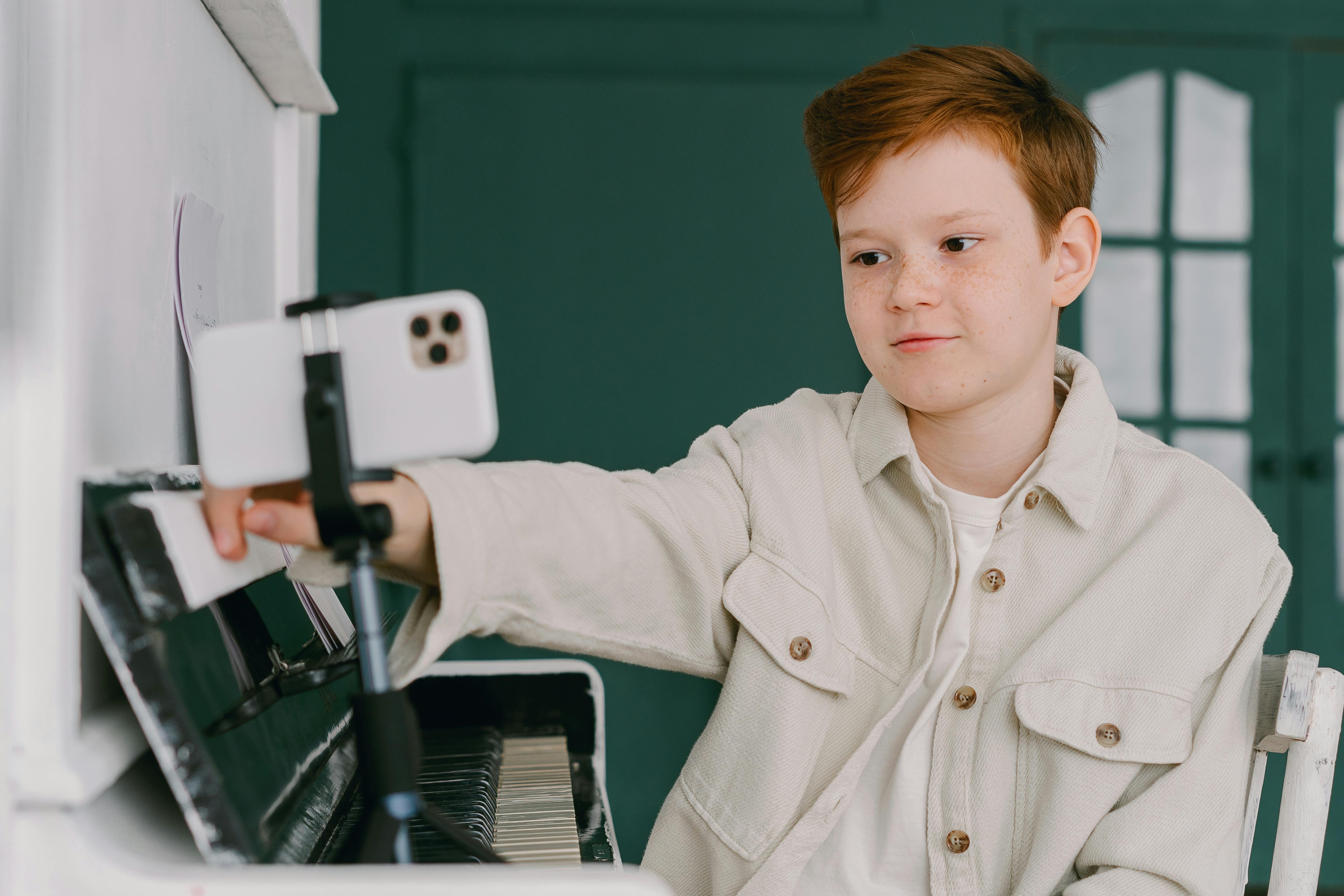 a boy recording himself with his smartphone