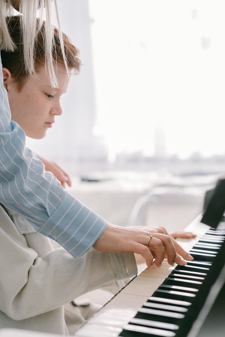 Adult  Person Teaching Boy Piano Lesson  