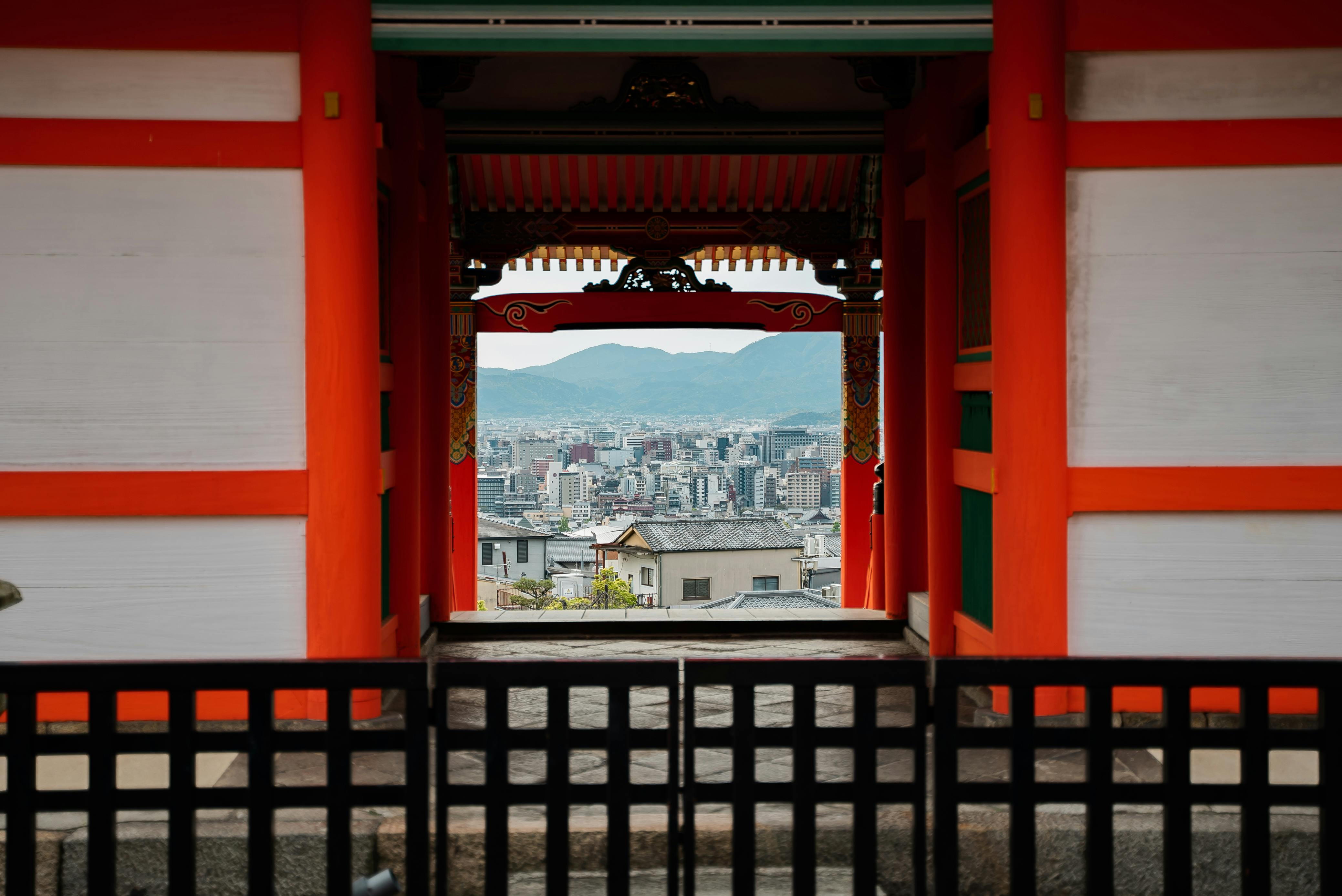 Stunning view of Kyoto city through a traditional Japanese temple gate, highlighting cultural architecture.