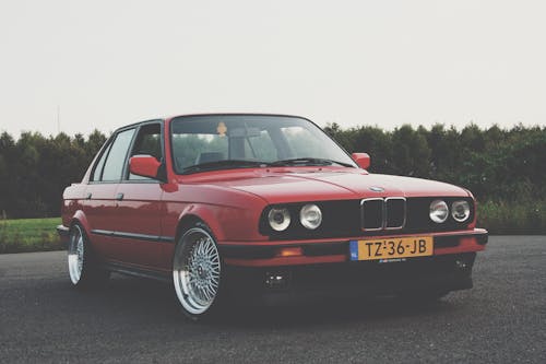 Photography of Red BMW on Asphalt Road