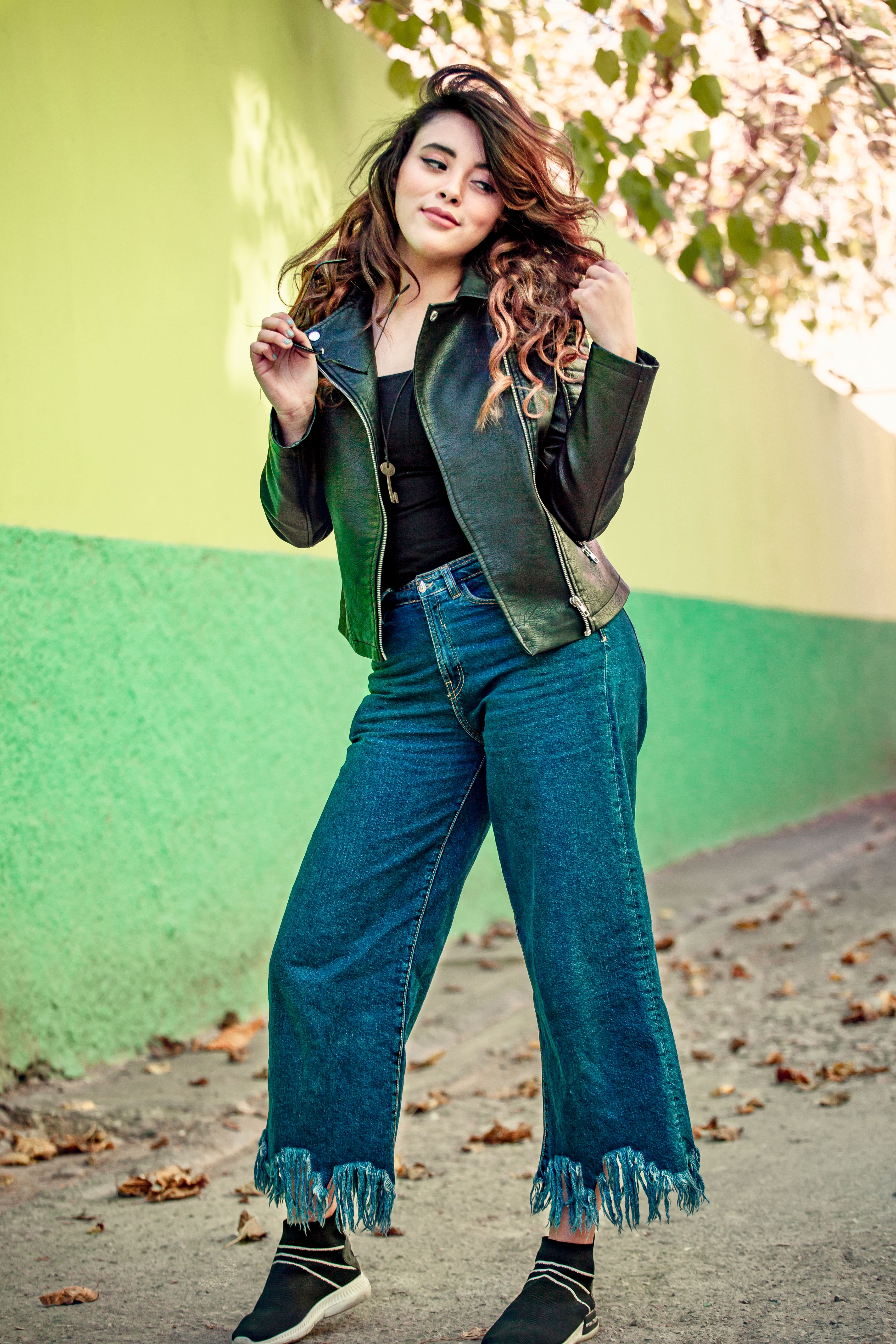 Woman in Black Leather Jacket and Blue Pants · Free Stock Photo