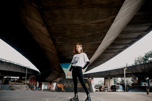 Young Woman in White Long Sleeve Shirt and Black Pants