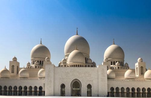 Free Stunning view of Sheikh Zayed Grand Mosque's white domes under a clear blue sky in Abu Dhabi. Stock Photo