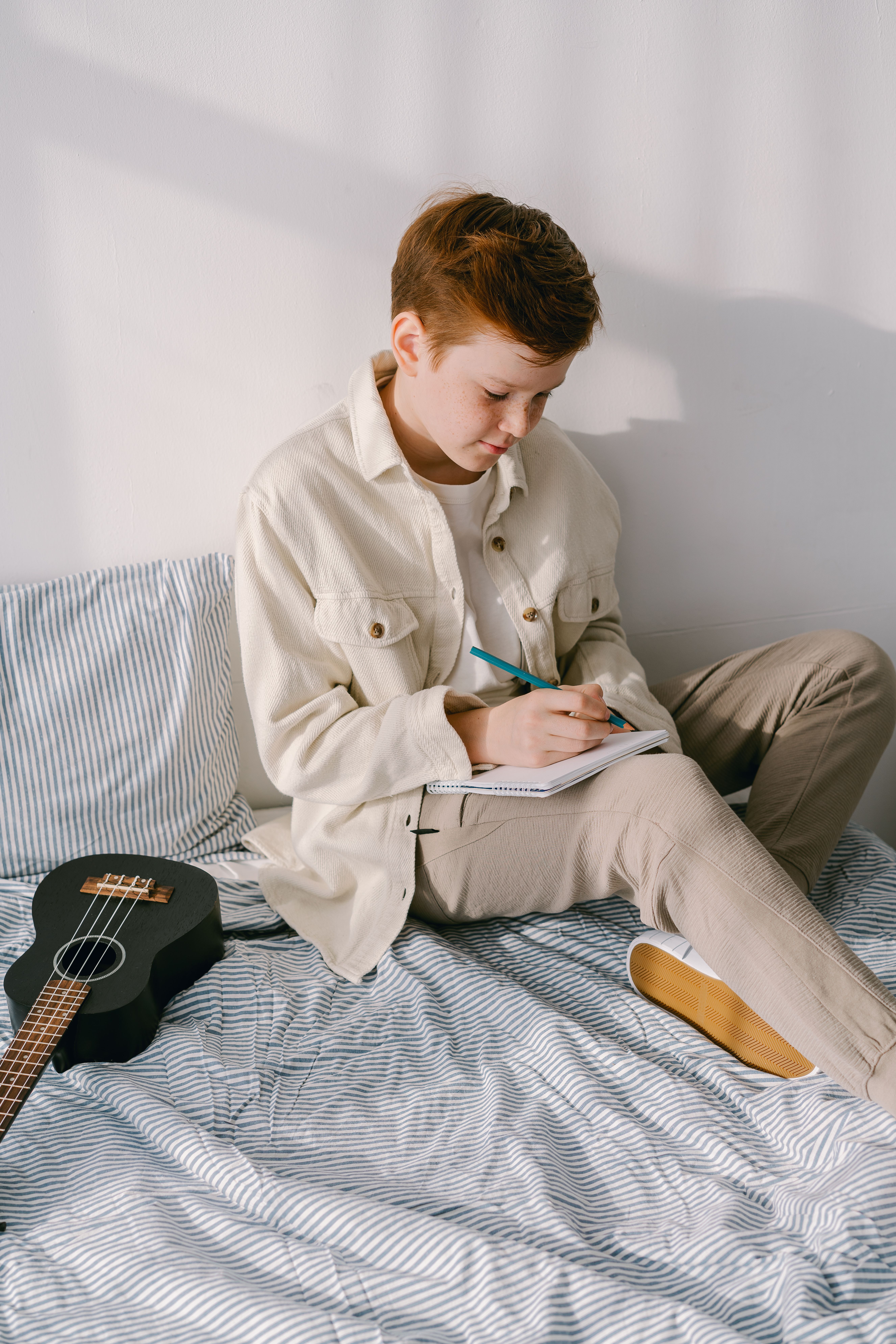 Boy writing on a Journal · Free Stock Photo