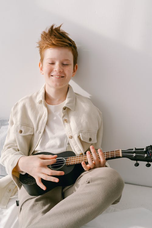 Free A Young Boy Leaning on the Wall with His Eyes Closed Stock Photo