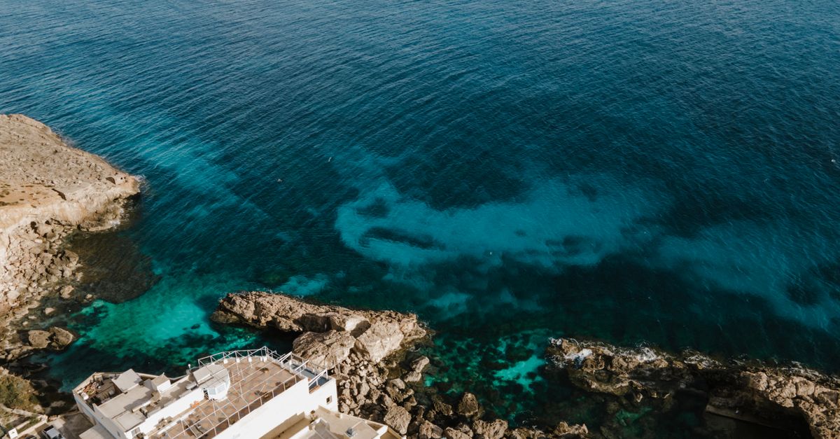 Stunning aerial view of Siggiewi, Malta showcasing turquoise waters and rocky coastline.