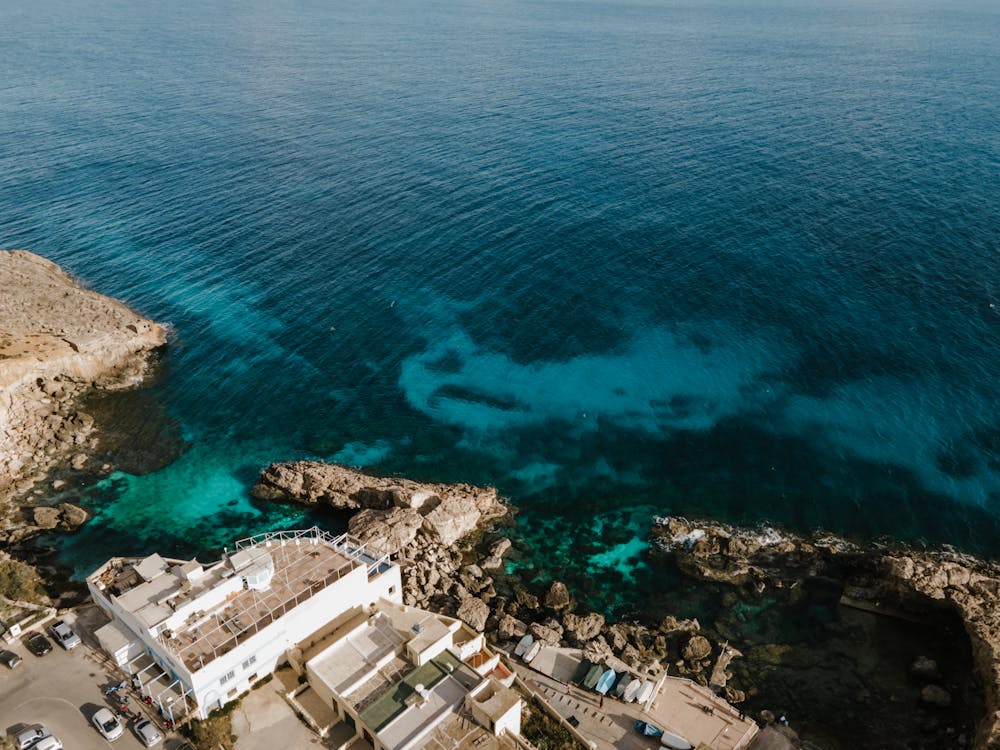 Aerial view of blue sea near rocks