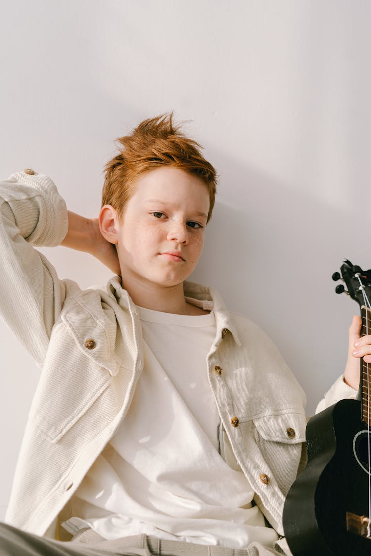 Boy In Beige Jacket With Hand On Nape