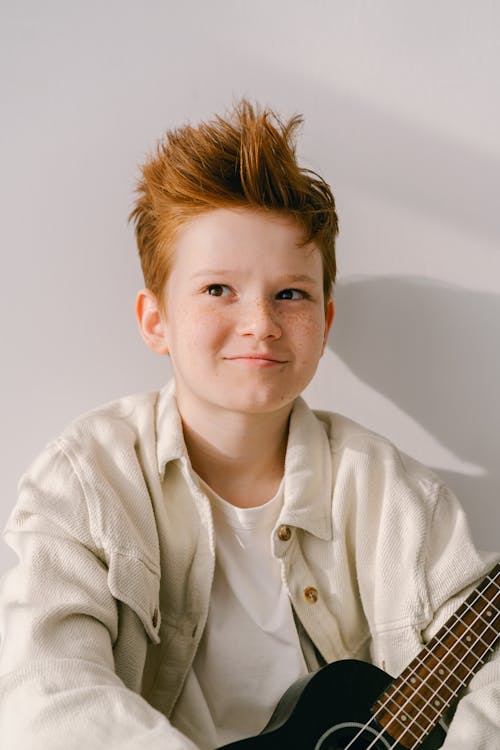 A Boy Holding a Ukulele