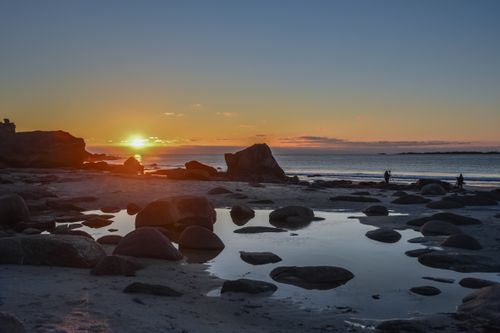 Free Breathtaking sunset over rocky beach in Nordland, Norway, creating a serene seascape. Stock Photo