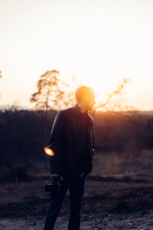 Free Close-Up Shot of a Man in Leather Jacket and Jeans during Sunset Stock Photo