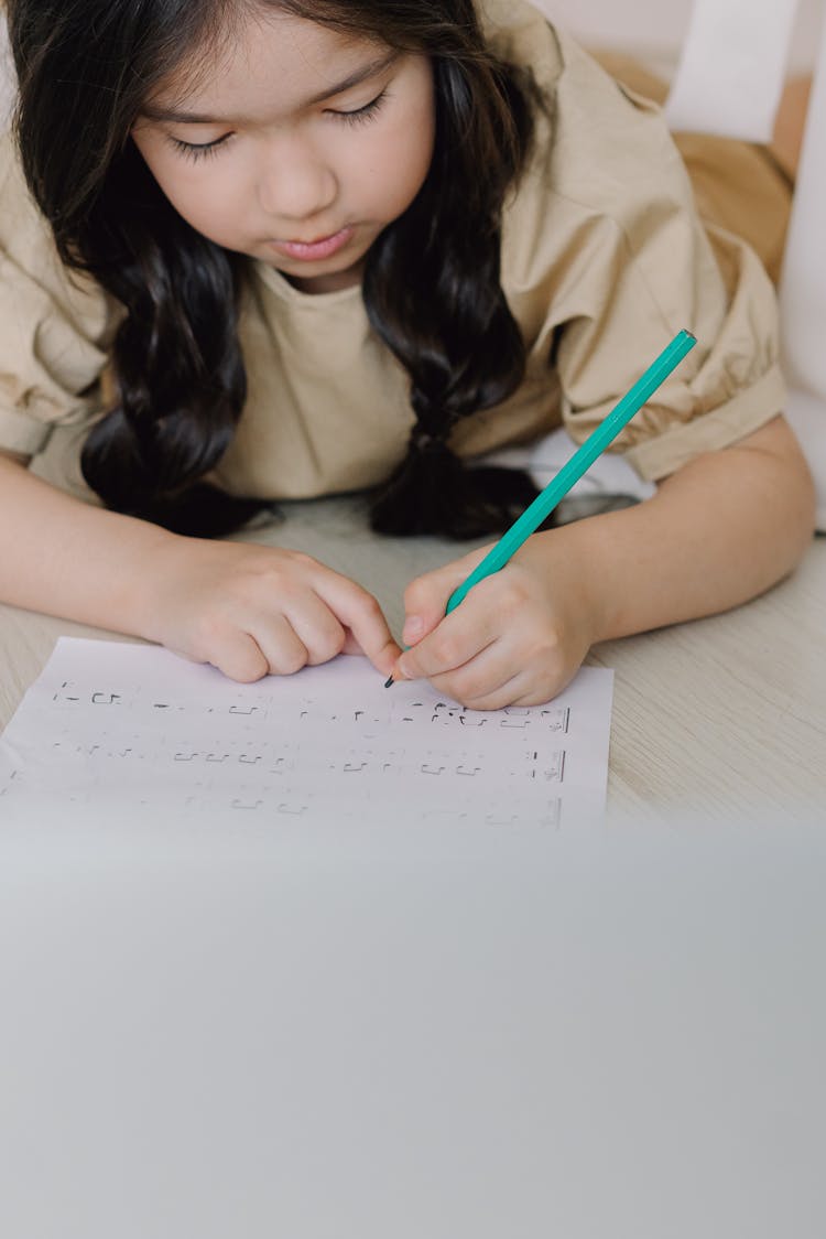 Girl Holding Green Pencil Writing Notes