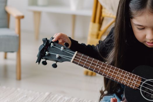 Woman Playing Guitar in Selective Focus Photography