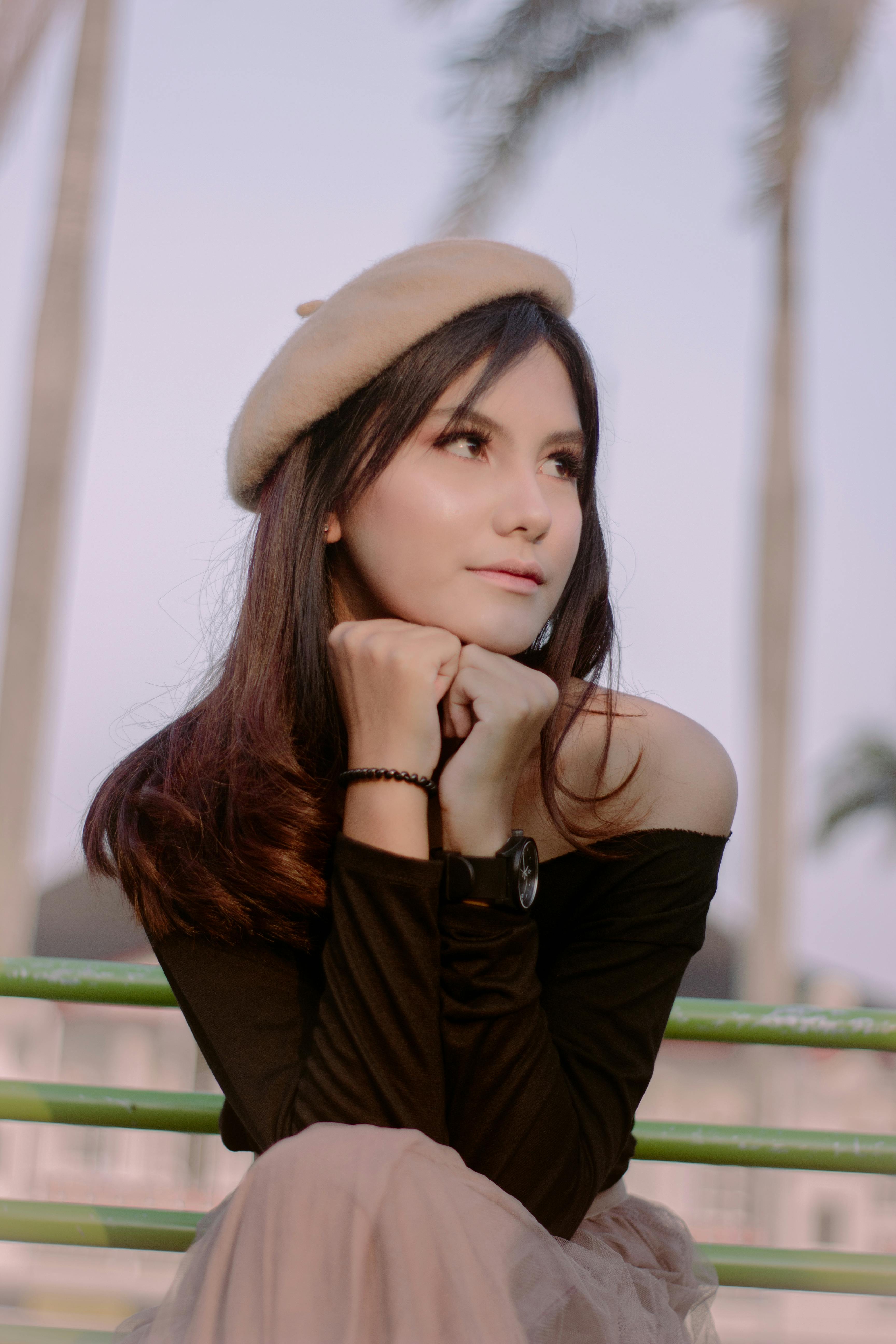 White Dog in Orange Raincoat Sitting on the Pavement · Free Stock Photo