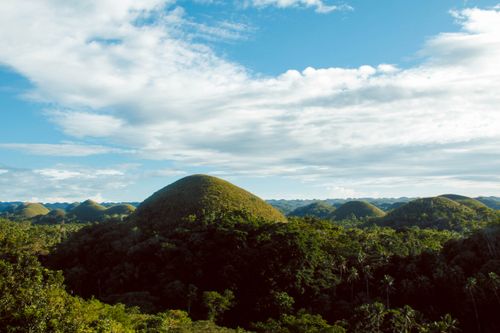Free Explore the iconic Chocolate Hills in Bohol, Philippines, under a bright blue sky. Stock Photo