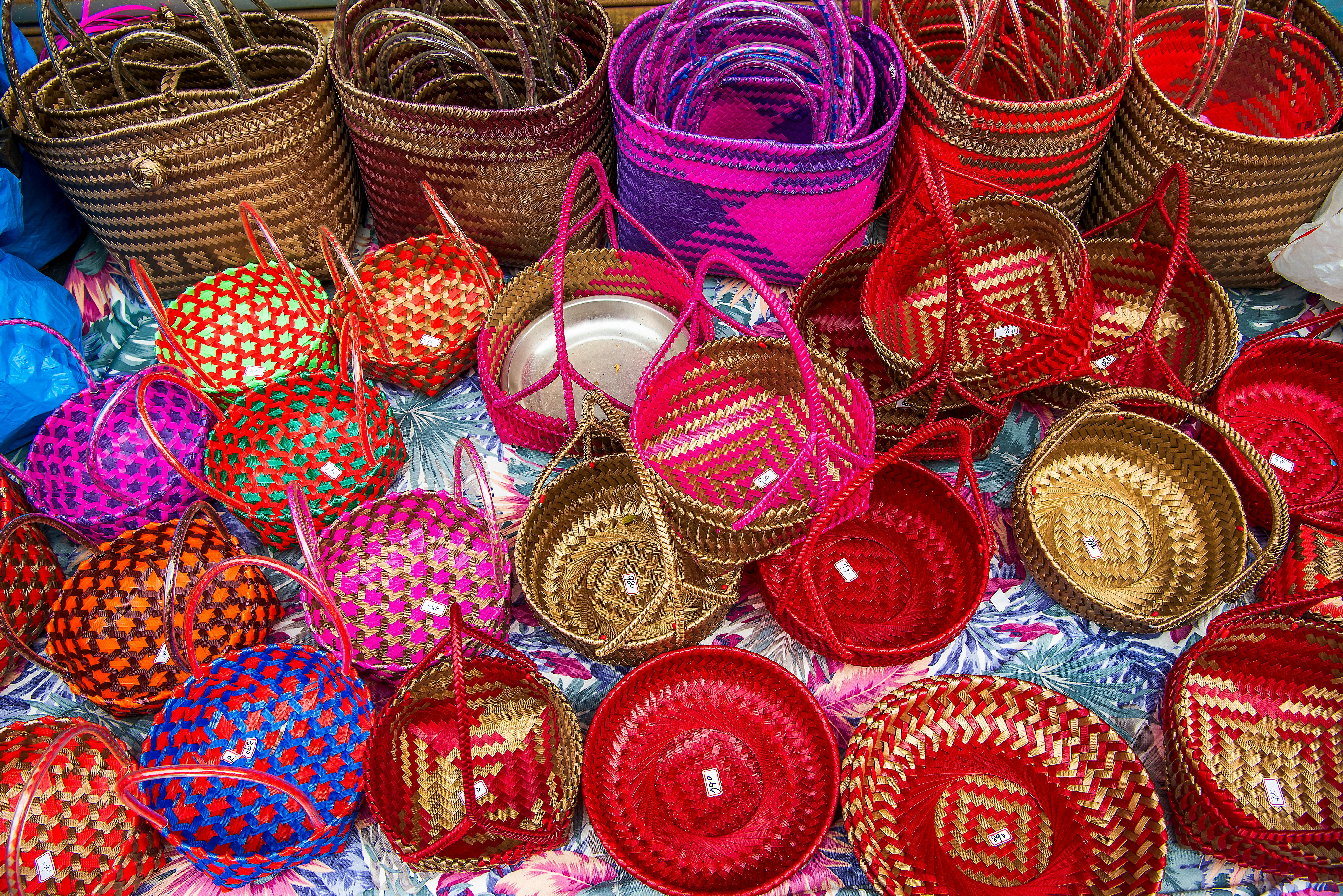 Colorful handwoven baskets displayed at a market in Taoyuan City, Taiwan, showcasing traditional craftsmanship.