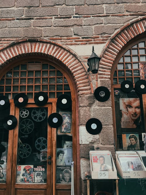 Close-up of a Facade of a Shop with Records and Magazines in City 