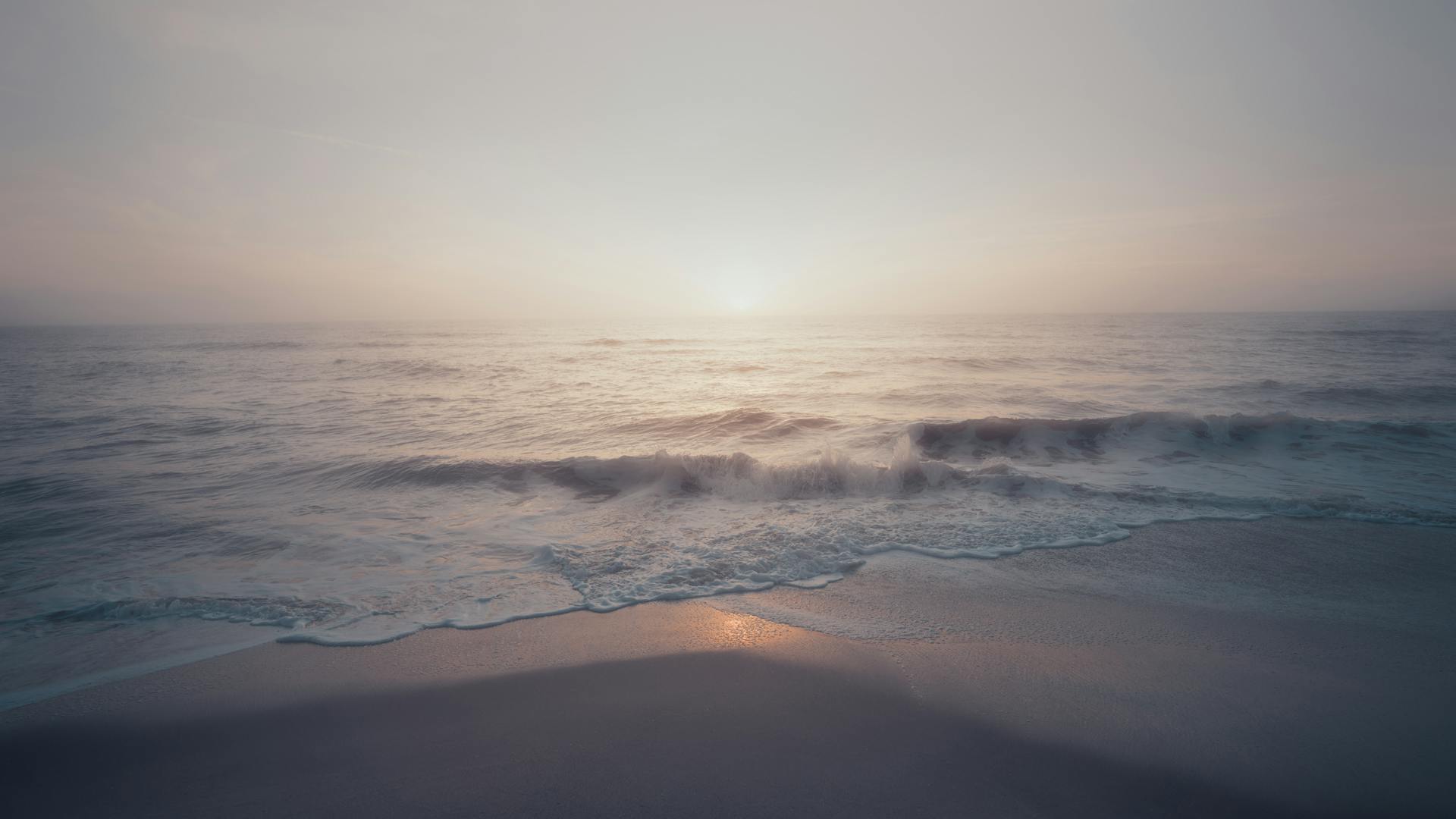 Peaceful ocean waves and soft sunrise light at Melbourne Beach, Florida.