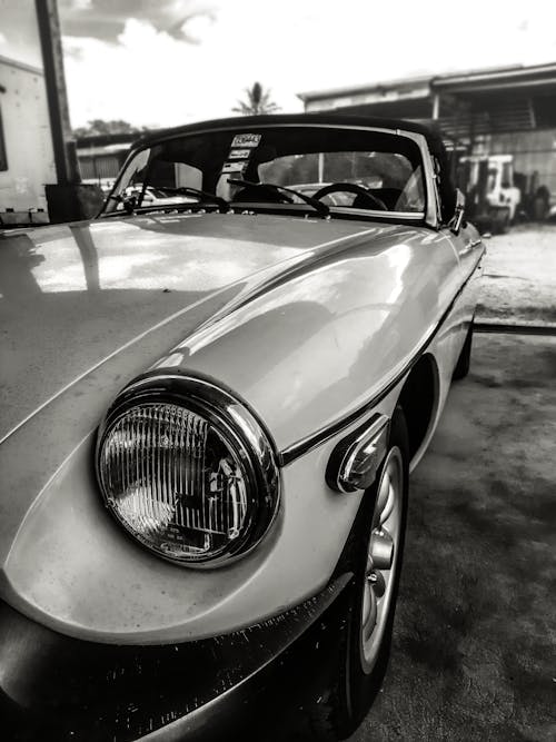 Grayscale Photo of Car in a Garage