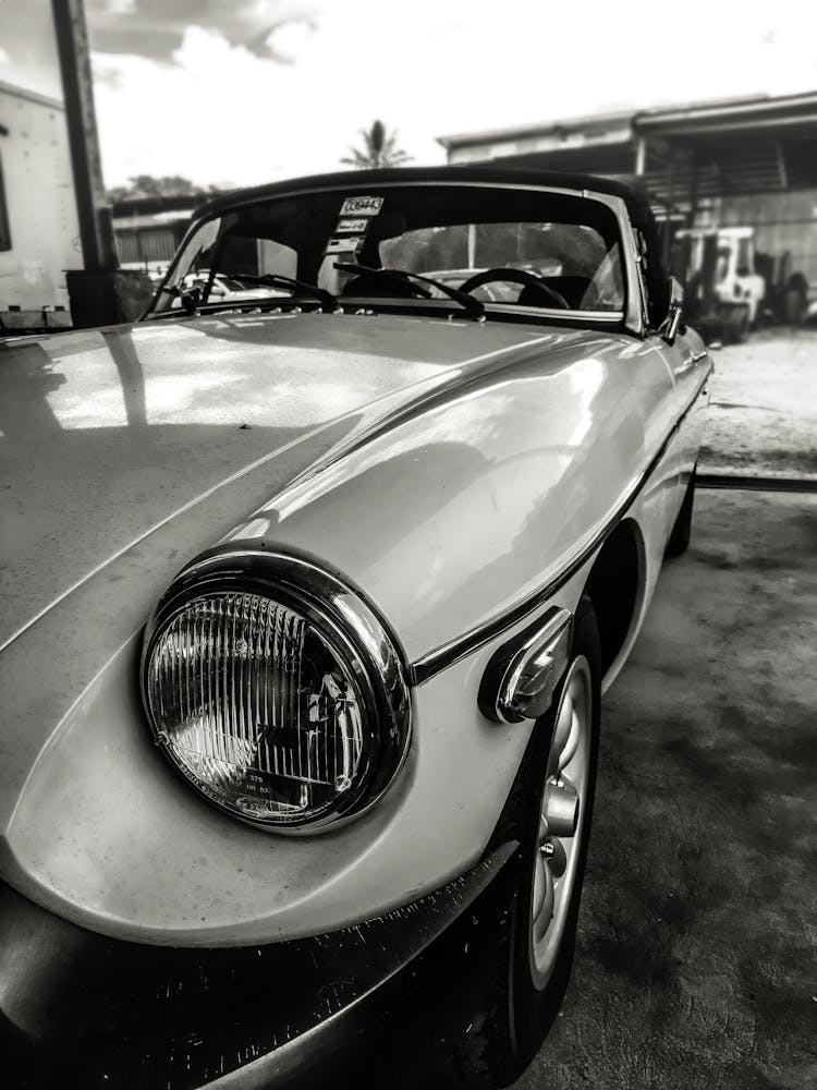 Grayscale Photo Of Car In A Garage