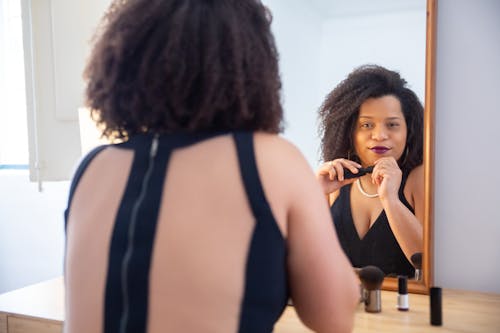 Free Woman Sitting in Front of the Mirror Stock Photo