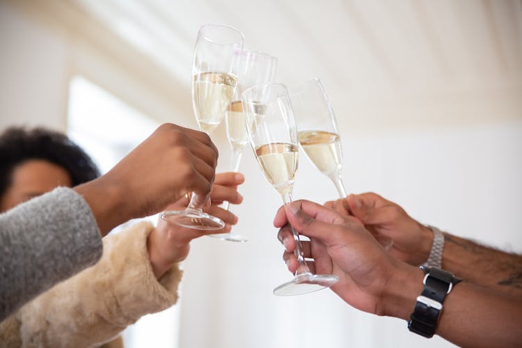 People Holding Glasses Of Wine