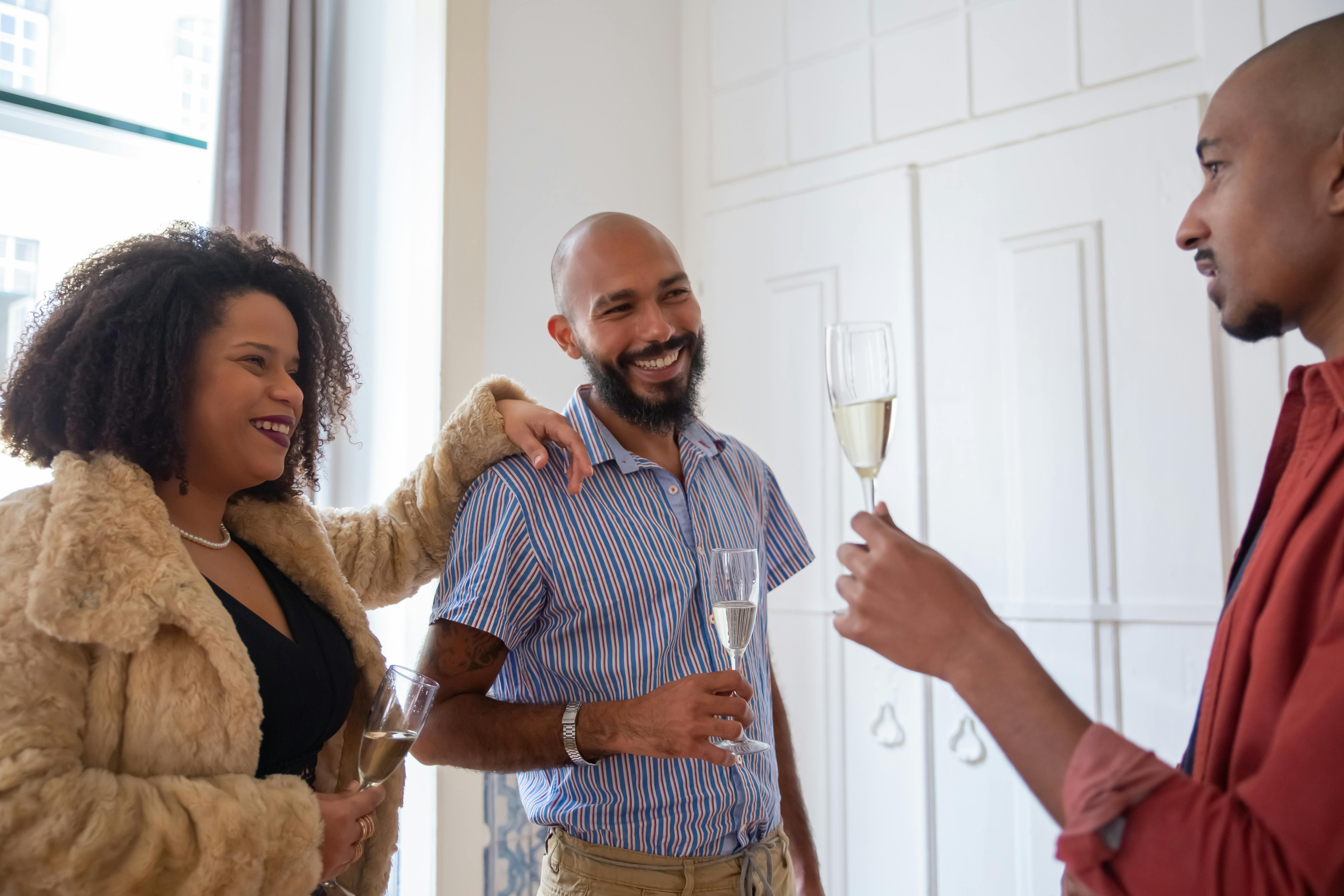A cheerful group of friends toasting with champagne indoors, celebrating togetherness.