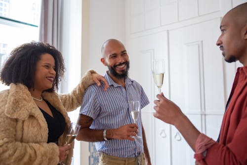 Free People Holding Champagne Glasses Stock Photo