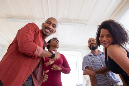 Free A lively group of friends enjoying a dance party indoors with vibrant energy and smiles. Stock Photo