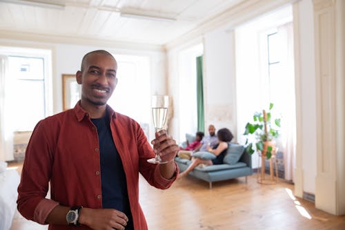 A Man Holding a Clear Wine Glass with Liquid