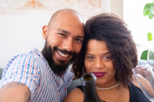 Free A Man and a Woman Posing Close Together Stock Photo