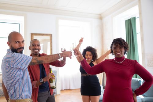 Free A diverse group of friends enjoying a celebratory toast with champagne indoors in Portugal. Stock Photo