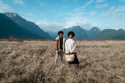 A Man and a Woman Standing on Grass Field