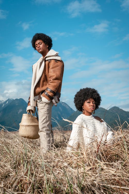 A Man and a Woman Posing in the Grass Field