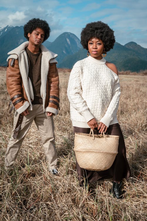 A Woman with a Woven Handbag Standing Besides a Man