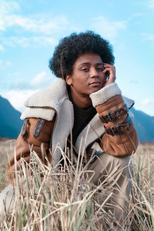 Free Fashion-forward african american man with afro posing in outdoor setting. Stock Photo