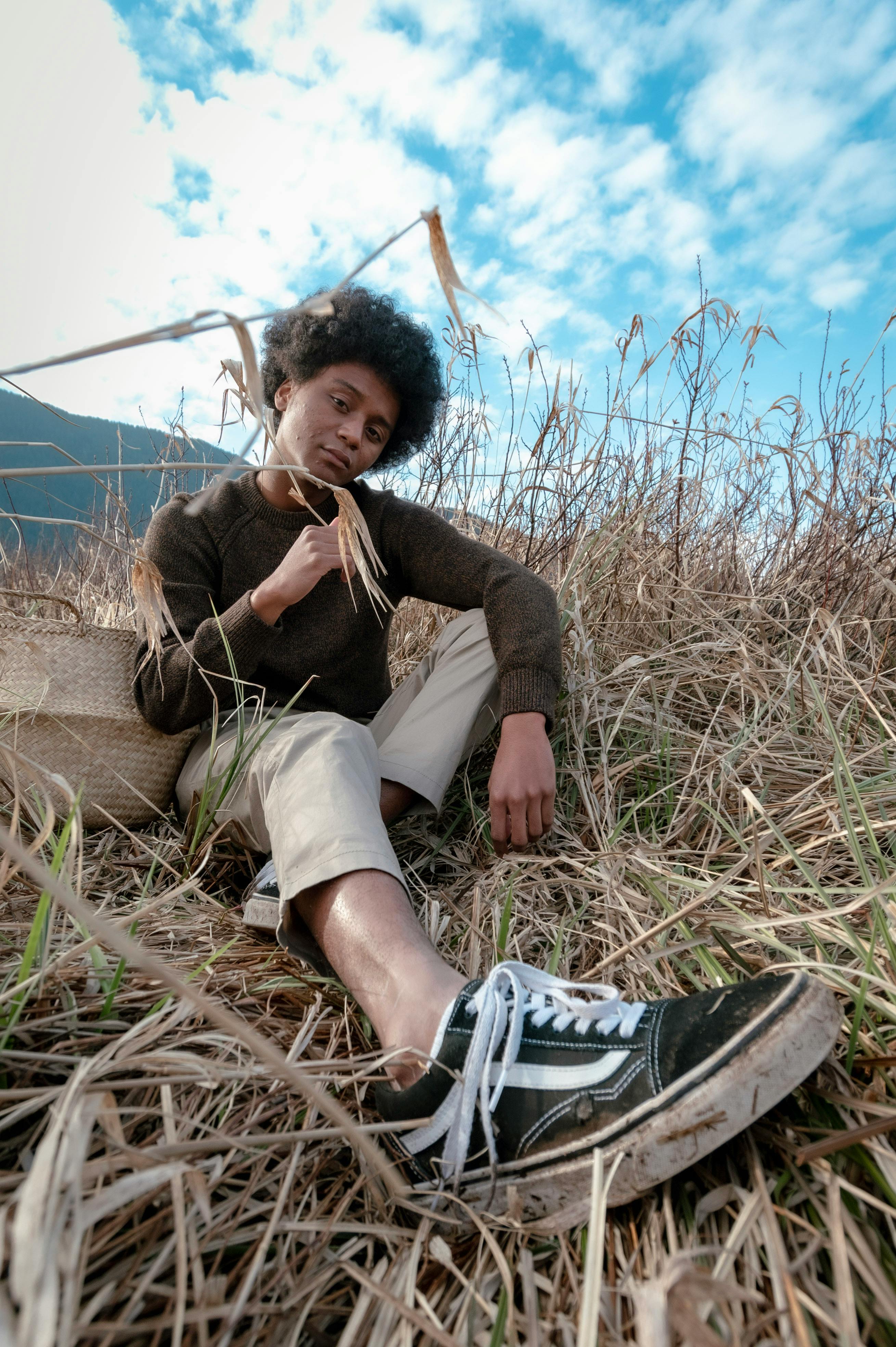 Man In Red And Black Zipup Jacket And Black Pants With Black Hat