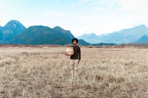 Kostnadsfri bild av afroamerikansk man, åkermark, bergen