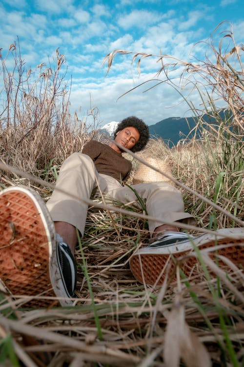 Free Man Lying Down on Grass Stock Photo