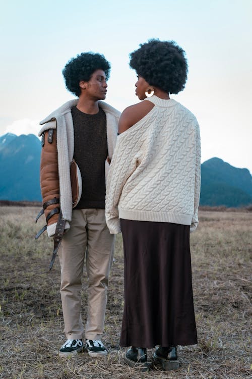 A Man and Woman Posing while Standing in a Field