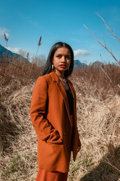 Woman in Brown Suit on Dry Meadow