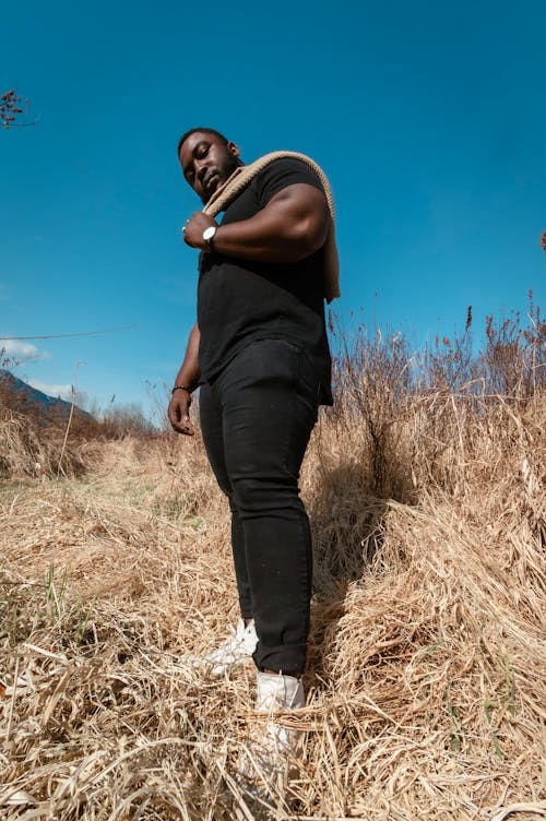 Low Angle Shot of Man in Black Shirt and Pants