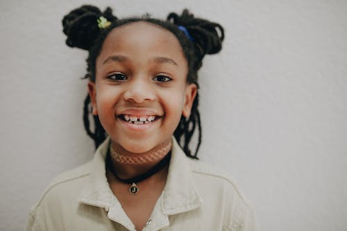 Free Close Up Photo of a Smiling Girl in Pigtails Stock Photo