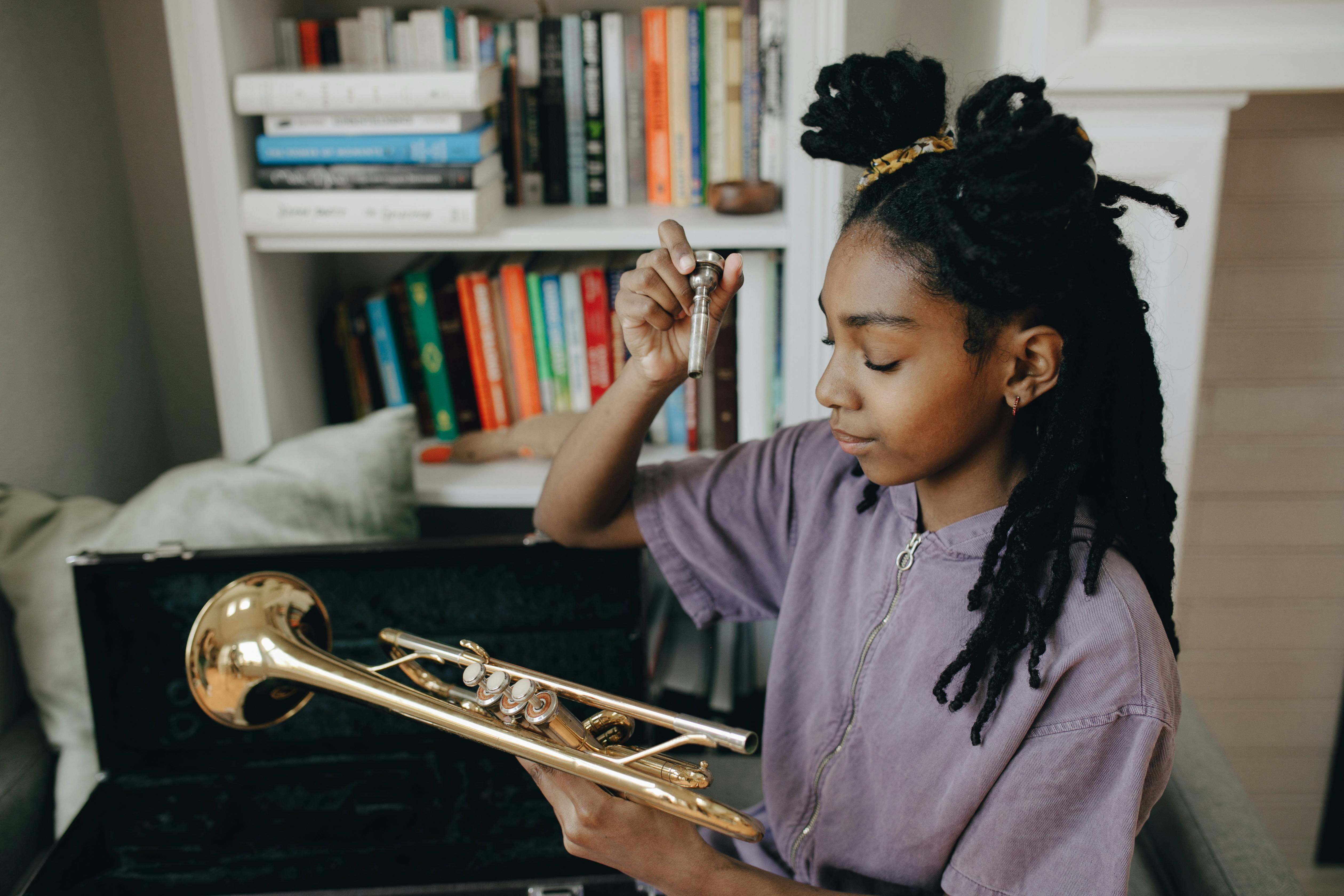 a young girl holding a trumpet