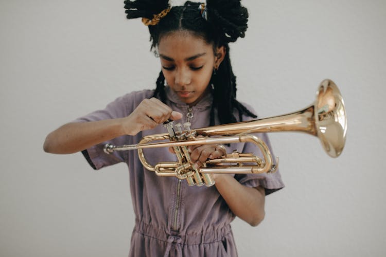 A Girl Holding A Trumpet