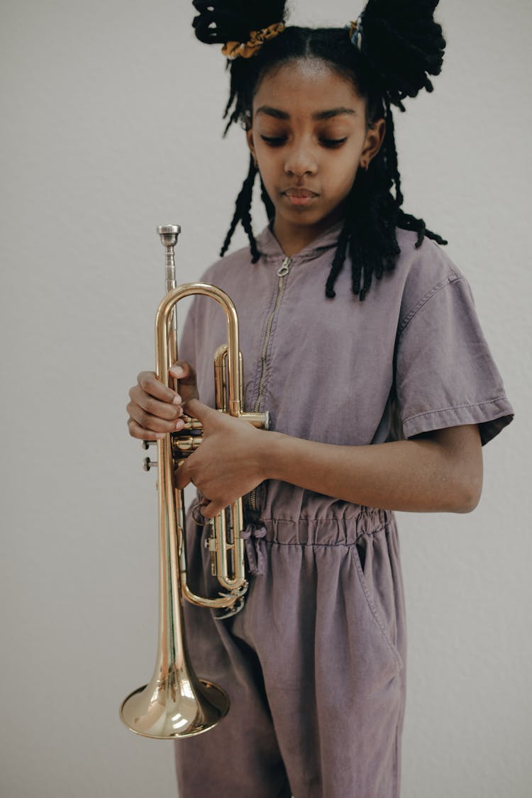 A Girl Holding A Trumpet