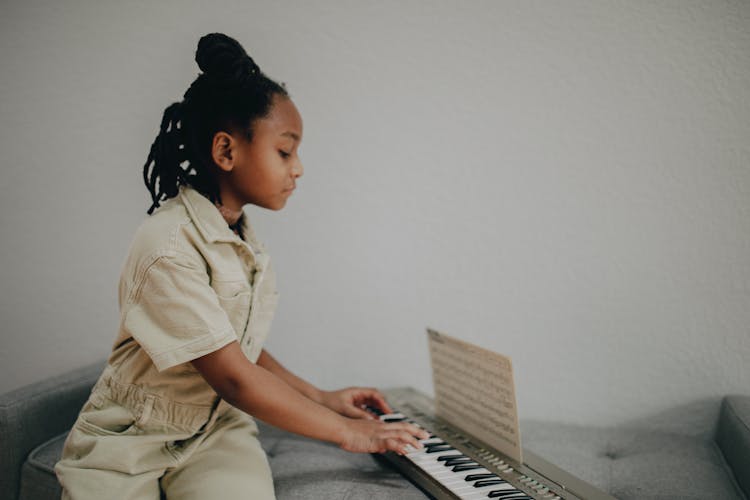 Girl Playing An Electronic Keyboard