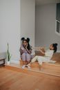 A Child Playing the Trumpet in her Sister's Ear