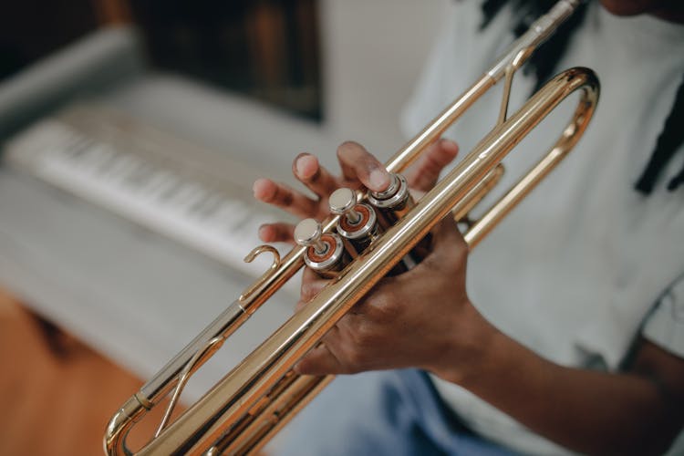 A Child Playing The Trumpet