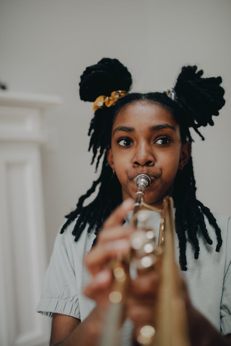 A Girl Playing A Trumpet